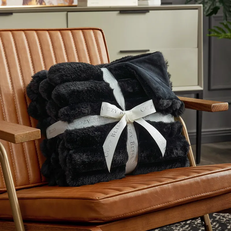 Black faux rabbit fur blanket tied with gift ribbon