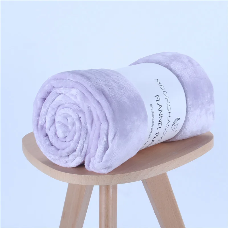 Lavender solid flannel blanket rolled with paper band